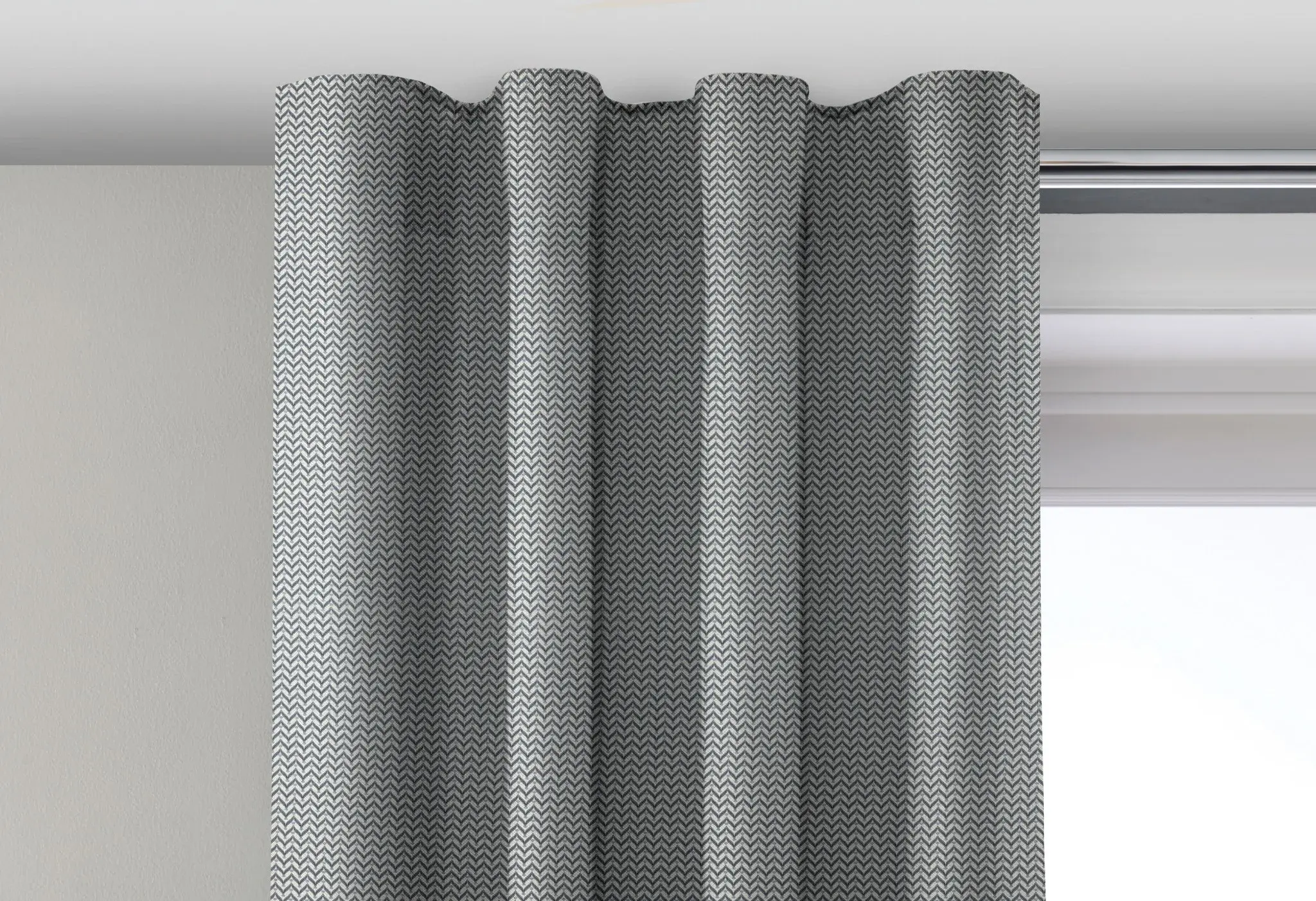 Curtain with a smooth wave heading fitted to a track
