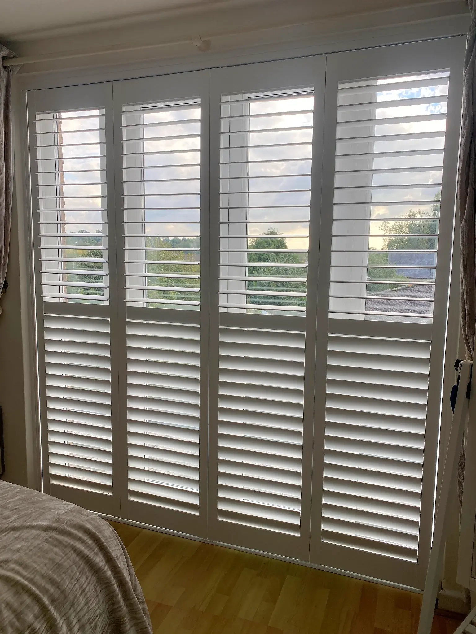 Pure White shutters with lower 76 mm louvres closed and upper louvres open
