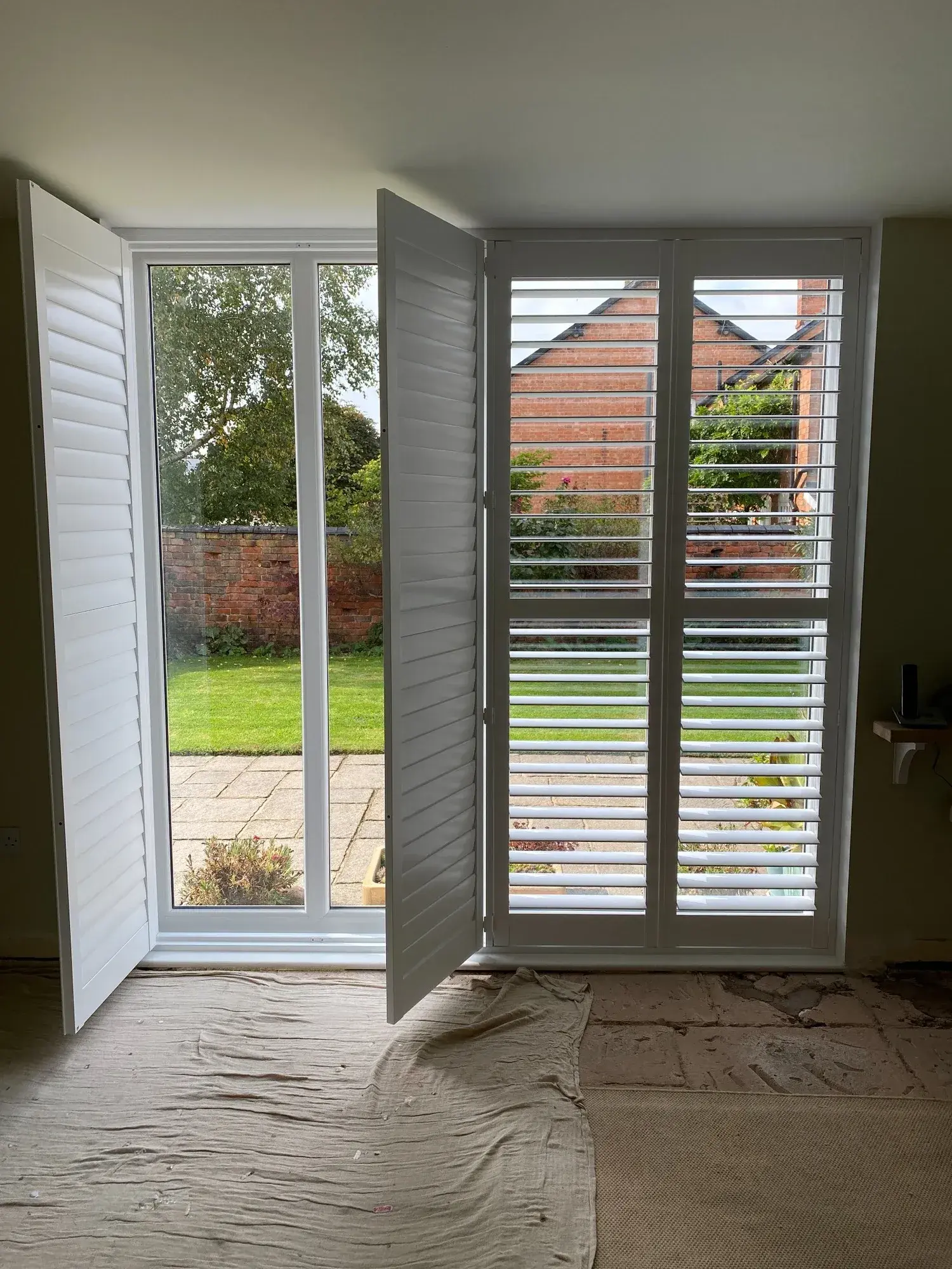One entrance shutter panel opened with the remaining wooden panels in place