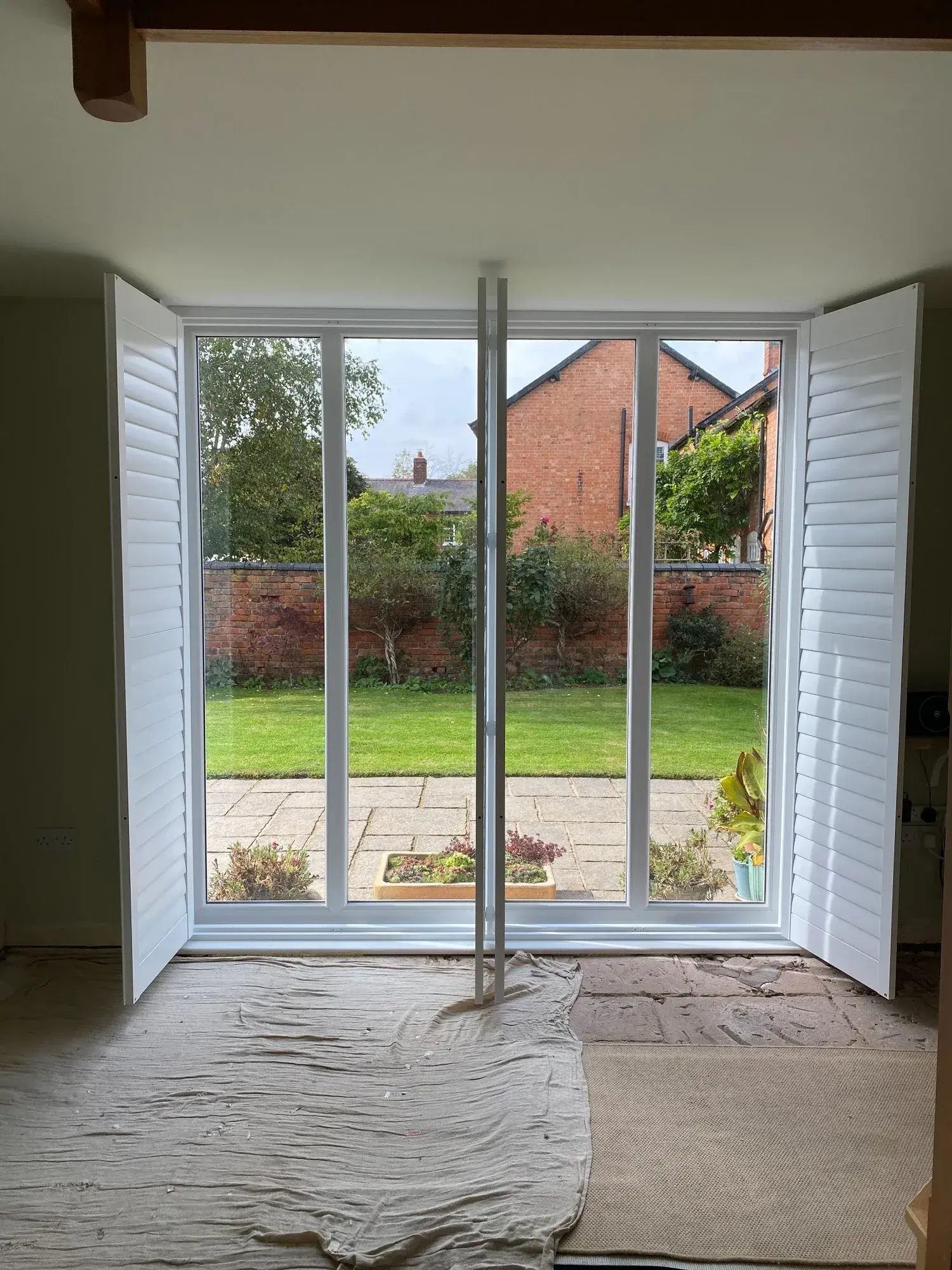Entrance shutter panels folded back to either side of the tall glazing