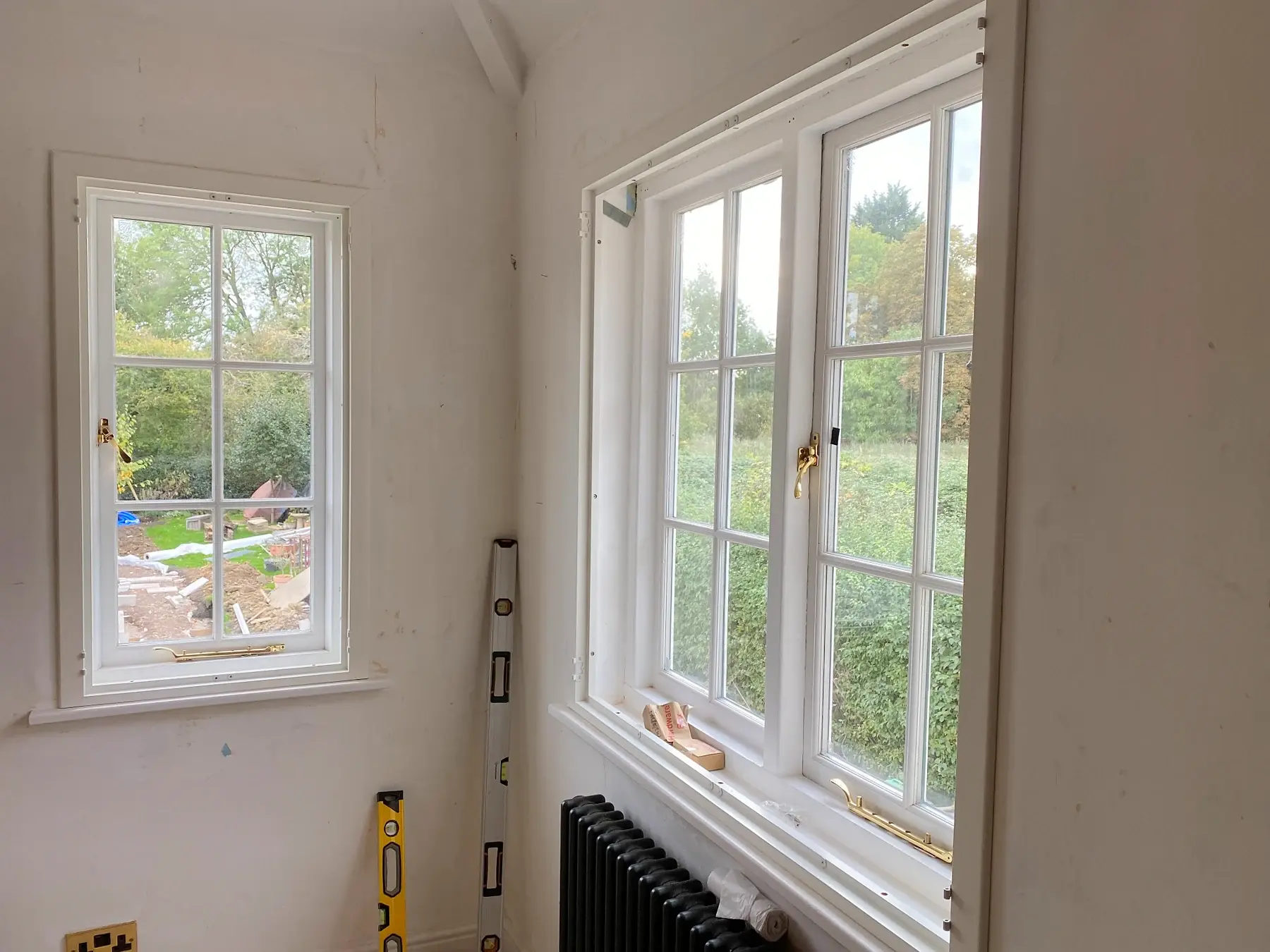 Adjacent windows before the solid panel shutter installation in Market Harborough