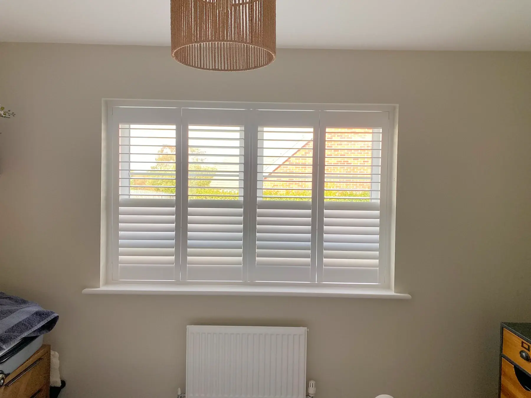 Full-height shutters with 63 mm louvres in Wellingborough: A closer view of the bedroom shutters.