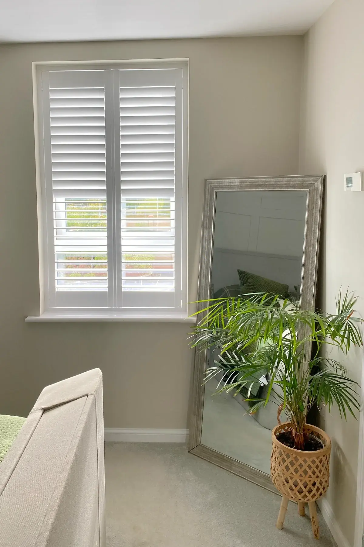 Full-height shutters with 63 mm louvres in Wellingborough: Full-height shutters fitted to a narrow window.