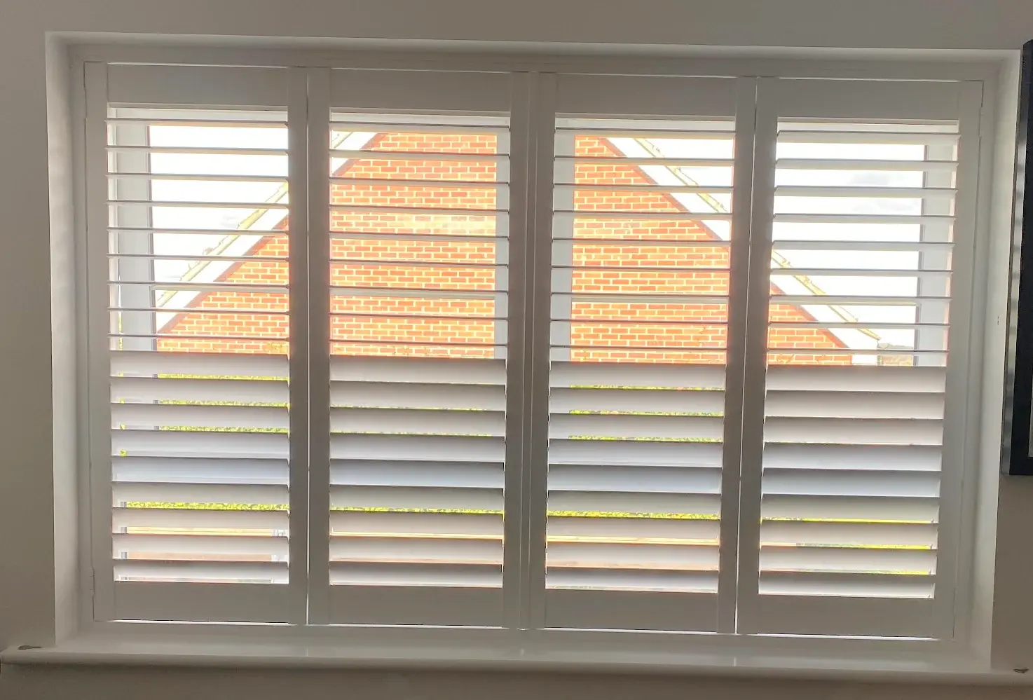 Full-height shutters with 63 mm louvres in Wellingborough: The completed shutters at the study window.