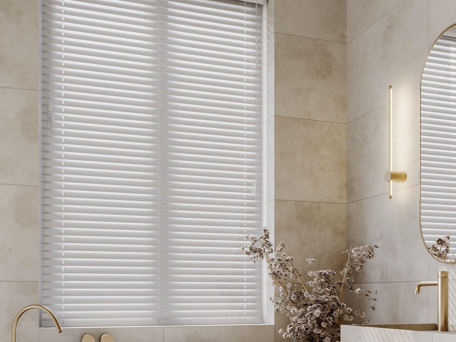 White smooth-finish faux wood venetian blind in an elegant bathroom beside a freestanding bath