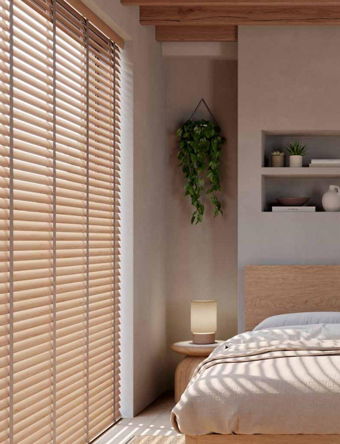 Light natural wood venetian blinds on a patio door in a modern bedroom