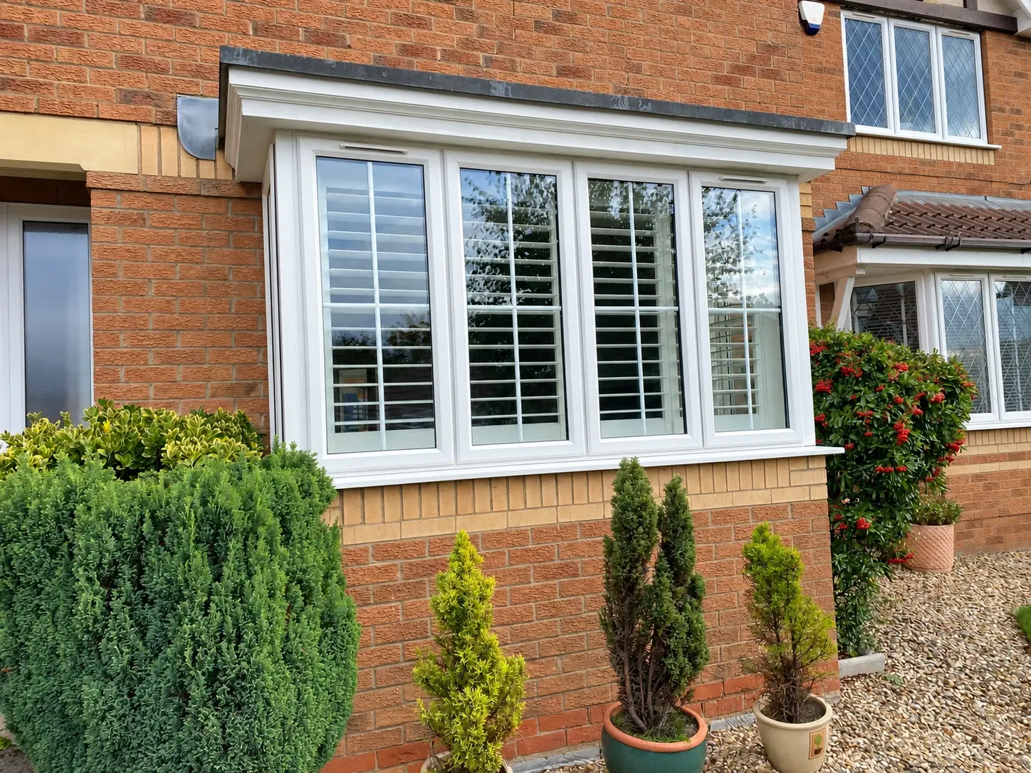 Completed wooden shutters viewed through the front glazing of the box bay
