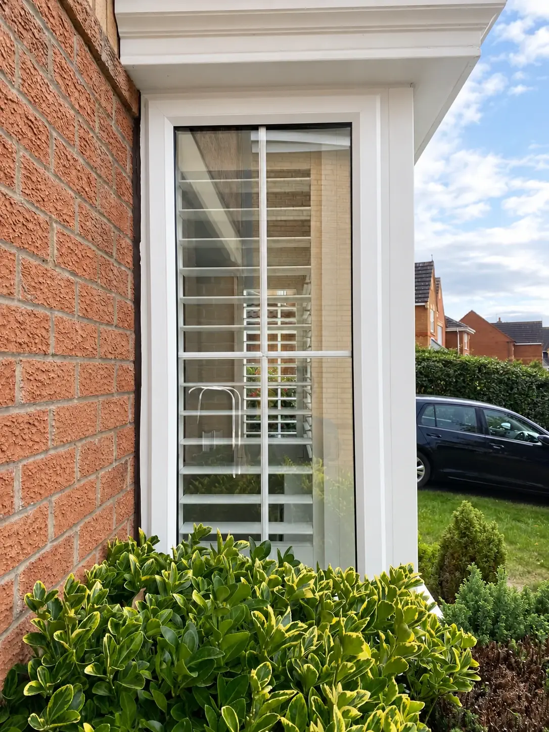 Silk White shutter fitted to the narrow side window of the box bay
