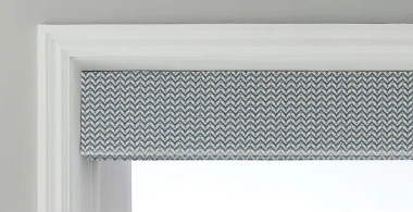 Grey herringbone Roman blind in Stacked fold, fitted to a window recess